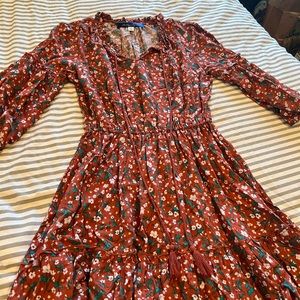Knee length orange floral dress.